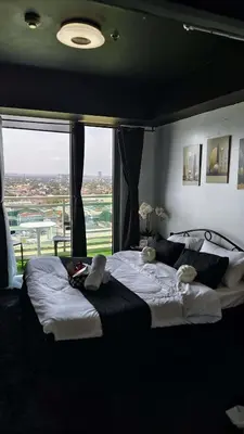 a bedroom with a large bed with a large window at Upside Down in Manila
