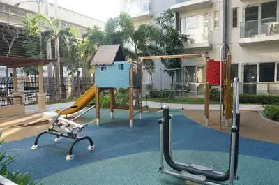 a playground with a slide and a play structure at Theresa Place Like Home in Manila