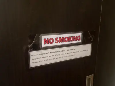 a no smoking sign hanging on a door at Theresa Place Like Home in Manila