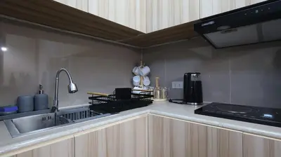 a kitchen with a sink and a stove top oven at Cozy Staycation in The Radiance Manila Bay in Manila