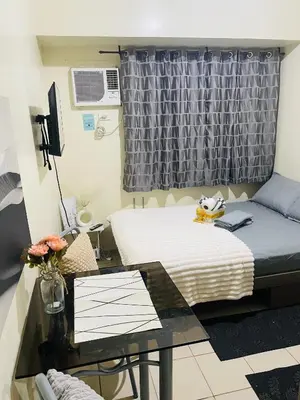 a small room with a bed and a desk at Haven Suites by Amf in Manila
