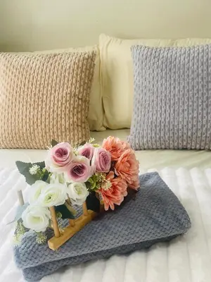 a bouquet of pink and white flowers on a bed at Haven Suites by Amf in Manila
