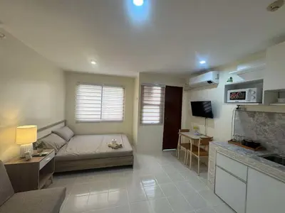a living room with a couch and a tv at Las Fallas Staycation in Santa Rosa