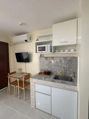 a kitchen with a sink and a table at Las Fallas Staycation in Santa Rosa