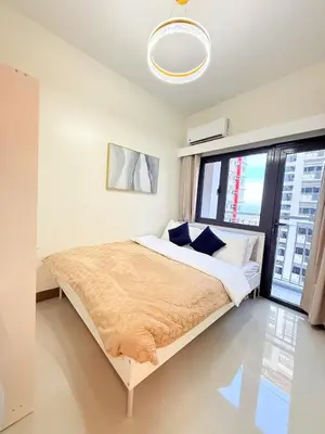 a bedroom with a bed and a large window at Bright Unit at Bloom near NAIA l WiFi Netflix BLOOM B02-0803 in Manila