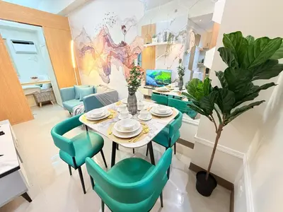 a dining room with a table and green chairs at Bright Unit at Bloom near NAIA l WiFi Netflix BLOOM B02-0803 in Manila