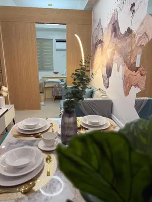 a dining room table with plates and dishes on it at Bright Unit at Bloom near NAIA l WiFi Netflix BLOOM B02-0803 in Manila