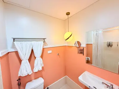 a bathroom with orange walls and a sink at Bright Unit at Bloom near NAIA l WiFi Netflix BLOOM B02-0803 in Manila