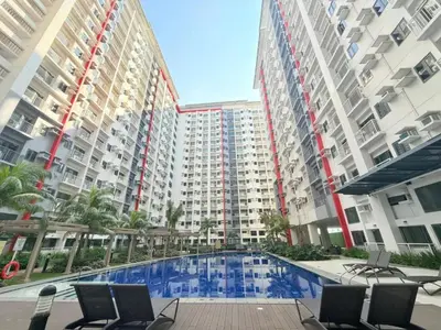 a large apartment complex with a swimming pool in front of buildings at Bright Unit at Bloom near NAIA l WiFi Netflix BLOOM B02-0803 in Manila