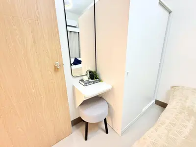 a bathroom with a sink and a mirror next to a bed at Bright Unit at Bloom near NAIA l WiFi Netflix BLOOM B02-0803 in Manila