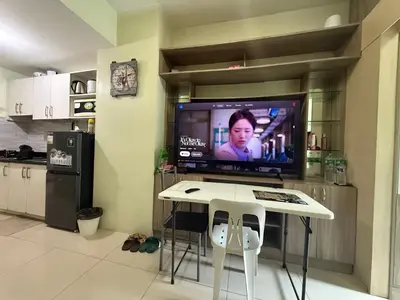 a kitchen with a table and a tv in a room at 1BR Staycation at JAZZ Makati 29F 65 Smart TV in Manila