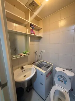 a small bathroom with a toilet and a sink at 1BR Staycation at JAZZ Makati 29F 65 Smart TV in Manila