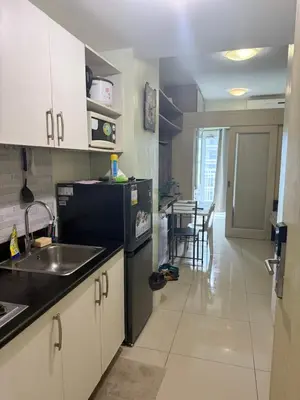 a kitchen with a sink and a counter top at 1BR Staycation at JAZZ Makati 29F 65 Smart TV in Manila
