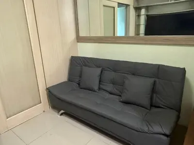 a couch sitting in a corner of a room at 1BR Staycation at JAZZ Makati 29F 65 Smart TV in Manila