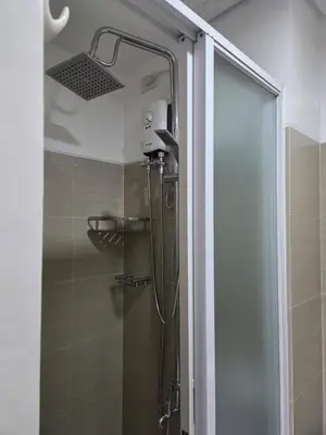 a shower with a shower head in a bathroom at Shore 1 Residences in Manila