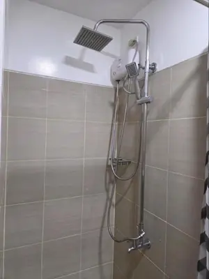 a shower with a shower head in a bathroom at Shore 1 Residences in Manila