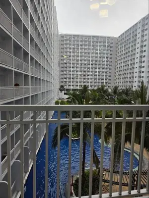 a view from a balcony of a building with a swimming pool at Shore 1 Residences in Manila