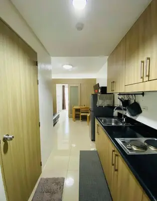 a kitchen with a sink and a counter top at Shore 1 Residences in Manila