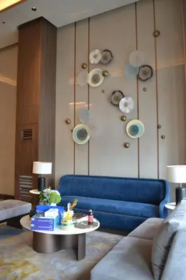 a living room with a blue couch and a table at Cozy Gentry Manor TV Netflix Seaview near Okada MOA17V in Manila
