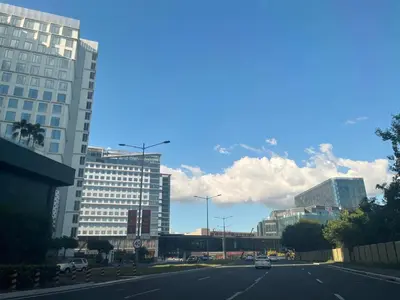 an empty street in a city with tall buildings at Gentry Manor WiFi Netflix&Balcony Near Okada NAIA in Manila