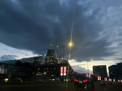 a city with a building and cars on a street at Gentry Manor WiFi Netflix&Balcony Near Okada NAIA in Manila