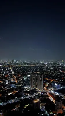 a view of a city at night with lights at Air Residences Makati CBD 1BR w Balcony in Manila