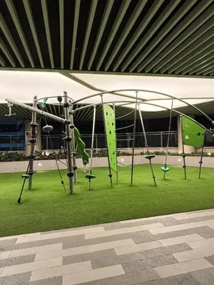 a playground with a slide and swings at Air Residences Makati CBD 1BR w Balcony in Manila