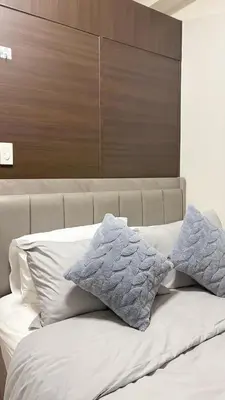 a bed with two pillows on top of it at Air Residences Makati CBD 1BR w Balcony in Manila