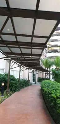 a covered walkway in a building with a roof at AC's Suite in Manila
