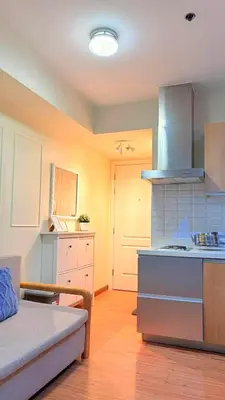 a kitchen with a couch and a stove in a room at Azure Urban Resort Residences in Manila