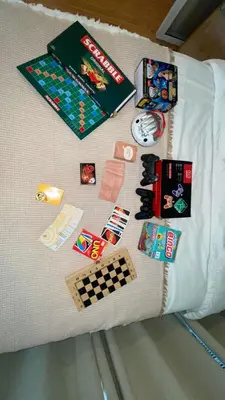 a group of toys and games on a bed at Azure Urban Resort Residences in Manila