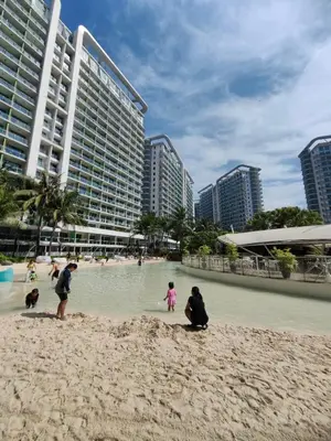 a group of people playing in the sand on the beach at Panatag Staycation by Yani at Azure Urban Residences, Parañaque in Manila
