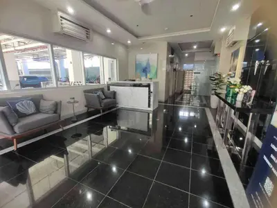 a living room with a couch and a table at Beirut Bliss Suite at Hope Residences Trece Martires in Trece Martires