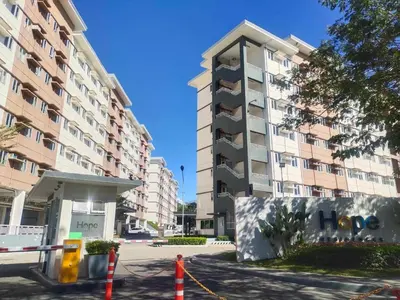 a large apartment building in front of a building at Beirut Bliss Suite at Hope Residences Trece Martires in Trece Martires