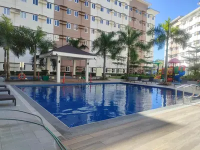 a large swimming pool in front of a building at Beirut Bliss Suite at Hope Residences Trece Martires in Trece Martires