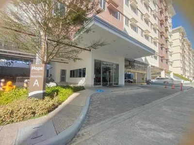a building with a sign in front of it at Beirut Bliss Suite at Hope Residences Trece Martires in Trece Martires