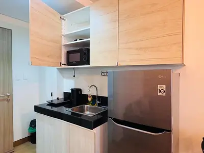 a small kitchen with a sink and a refrigerator at Beirut Bliss Suite at Hope Residences Trece Martires in Trece Martires