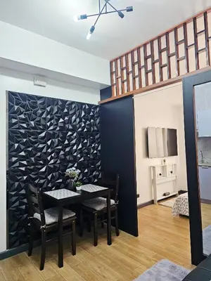 a dining room with a table and chairs at Paseo Verde Las Pinas - Sleeps 2 Adults 2 Children in Manila