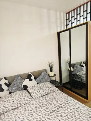 a bedroom with a bed and a large mirror at Paseo Verde Las Pinas - Sleeps 2 Adults 2 Children in Manila