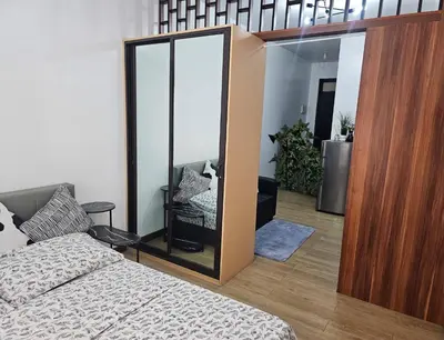 a bedroom with a mirror next to a bed at Paseo Verde Las Pinas - Sleeps 2 Adults 2 Children in Manila