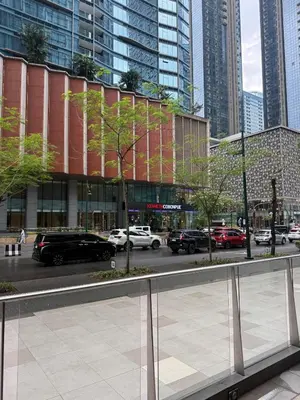 a city street with cars parked in front of a building at One uptown Residence,BGC, Manila 1bedroom in Manila