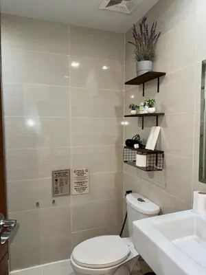a bathroom with a toilet and a sink at One uptown Residence,BGC, Manila 1bedroom in Manila