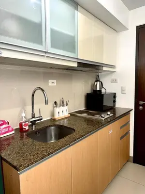 a kitchen with a sink and a counter top at One uptown Residence,BGC, Manila 1bedroom in Manila