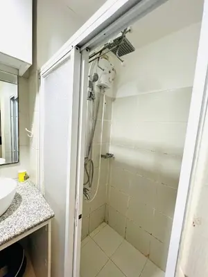 a bathroom with a shower and a sink at Sea Residences Elegant Place by Paul in Manila