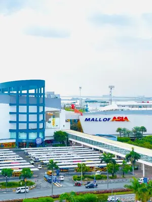 a mall of america with a parking lot and a building at Sea Residences Elegant Place by Paul in Manila