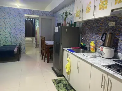 a kitchen with a refrigerator and a counter top at Budget Friendly Staycation -Ualat in Manila