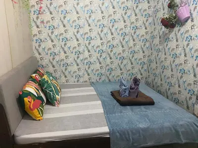 a small bed with a cat figurine sitting on it at Budget Friendly Staycation -Ualat in Manila