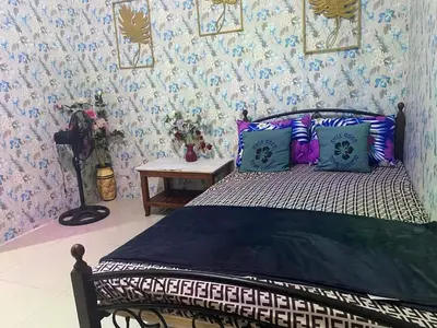 a bedroom with a bed with blue and white wallpaper at Budget Friendly Staycation -Ualat in Manila
