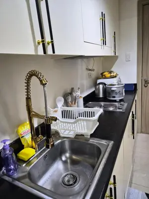 a kitchen sink with a dish drying rack on it at ZEN 2 SHORE RESIDENCES Tower A in Manila