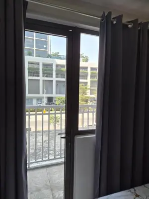 a bedroom door with a view of a balcony at ZEN 2 SHORE RESIDENCES Tower A in Manila